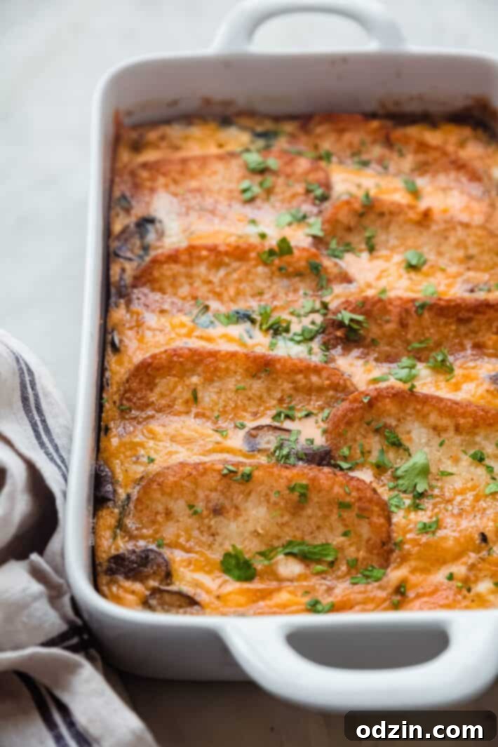 layered casserole in pan on white marble with towel
