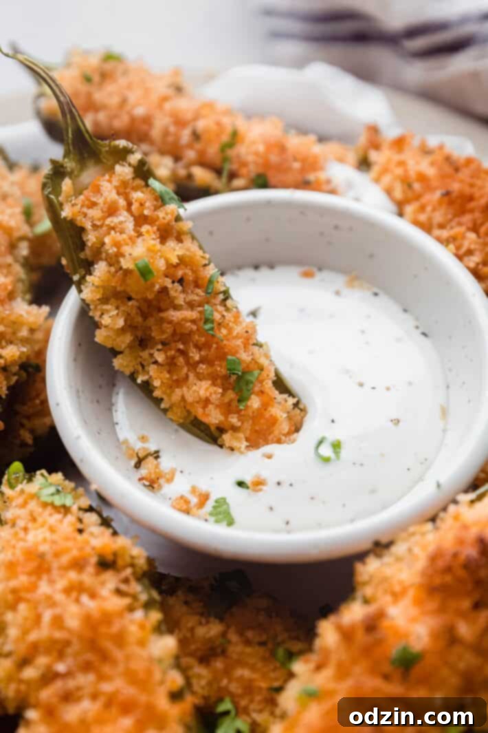 jalapeno popper dipped in ranch dressing on plate