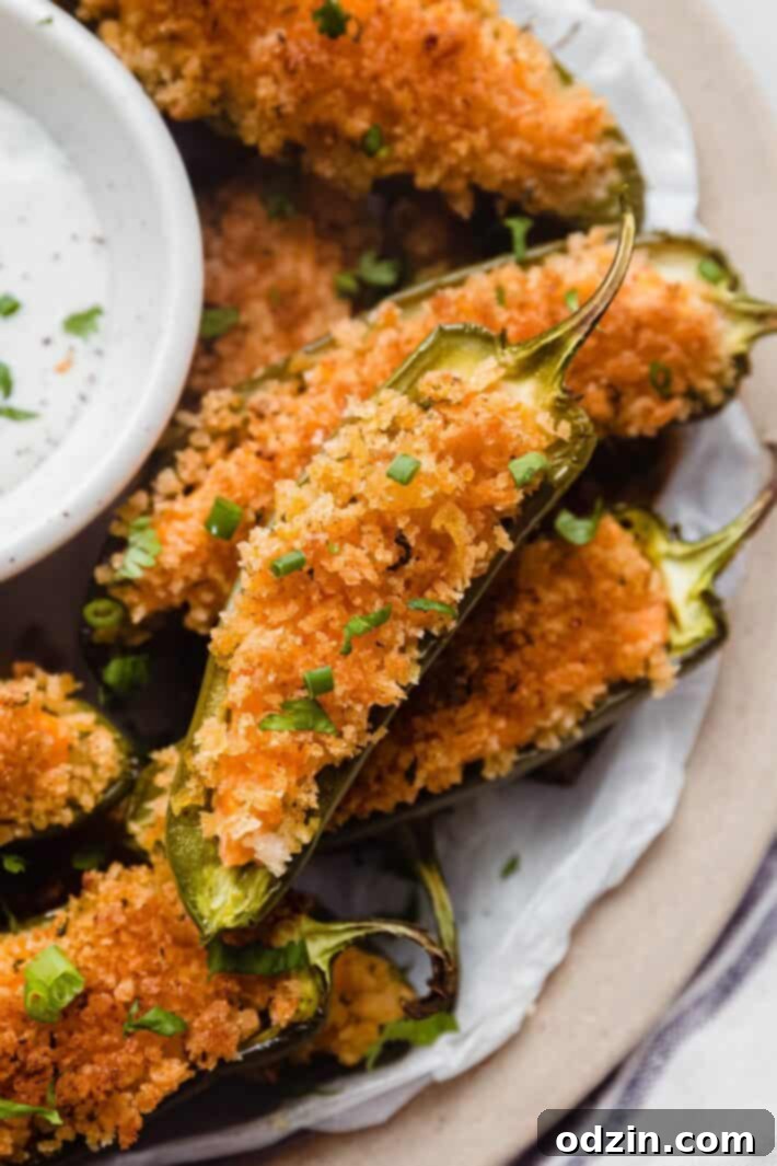 close up of jalapeno popper with scallions on top