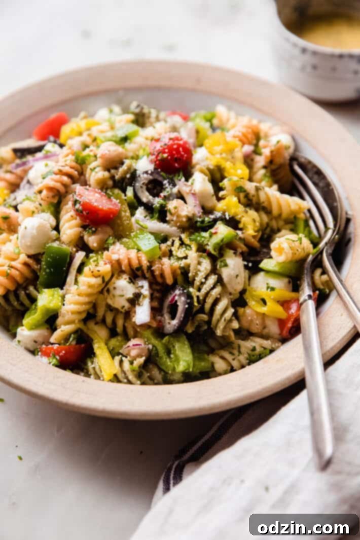 Crowd-Pleasing Zesty Italian Pasta Salad 3 showing veggies and parmesan on italian pasta salad