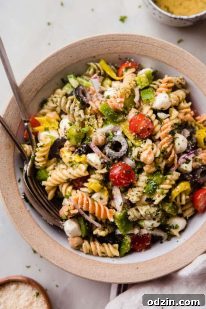 Crowd-Pleasing Zesty Italian Pasta Salad 8 italian pasta salad in rimmed bowl on white marble