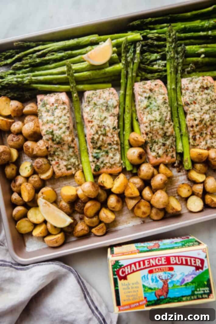 baked butter salmon, asparagus, and baby potatoes on white marble with butter package
