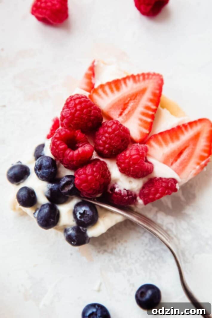 slice of dessert pizza with berries and a fork