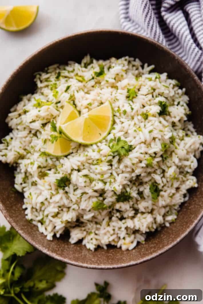 rice with cilantro and lime in olive bowl with lime wedges