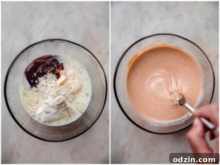 homemade bbq ranch dressing in a glass bowl with whisk