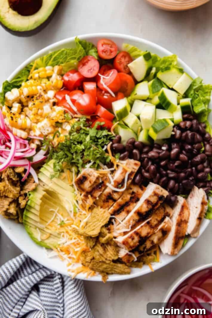 salad ingredients in a large white bowl before dressing, showcasing fresh produce