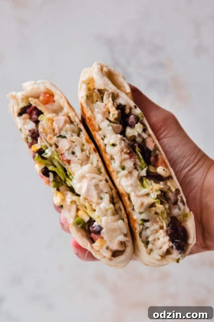 hand holding cut Crunchwrap showing layers