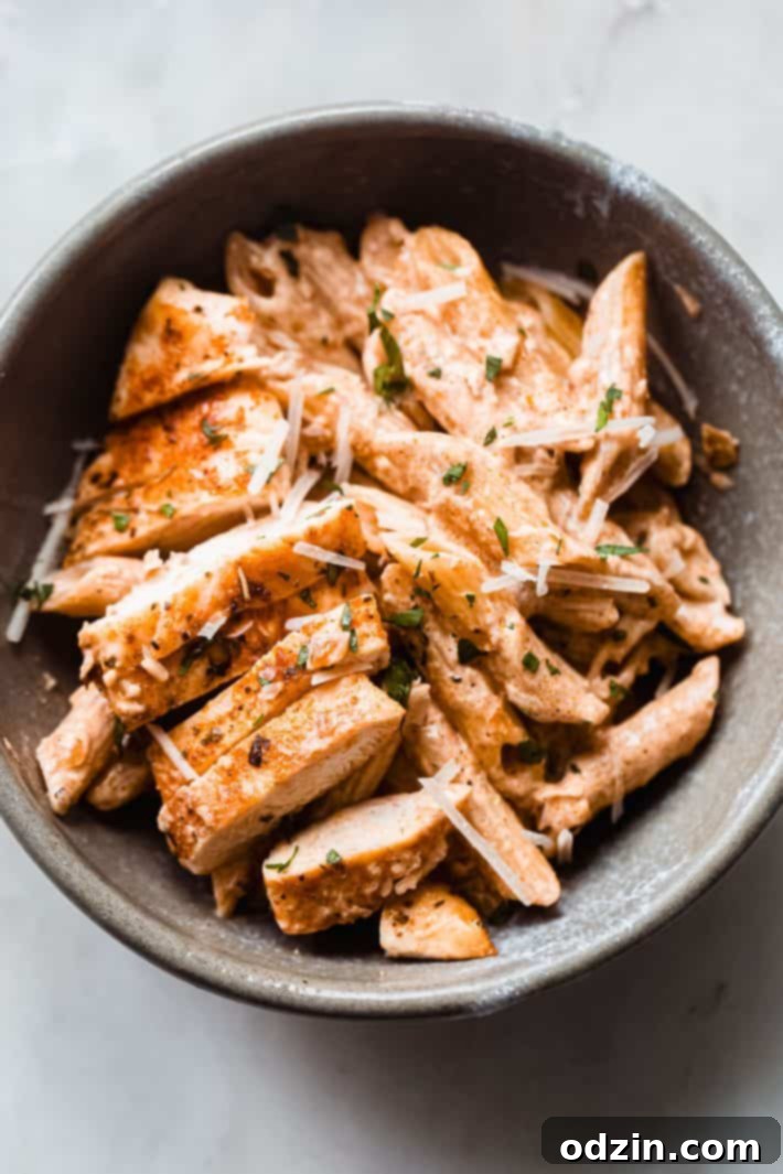 Bowl of Creamy Paprika Chicken Pasta on Marble Countertop
