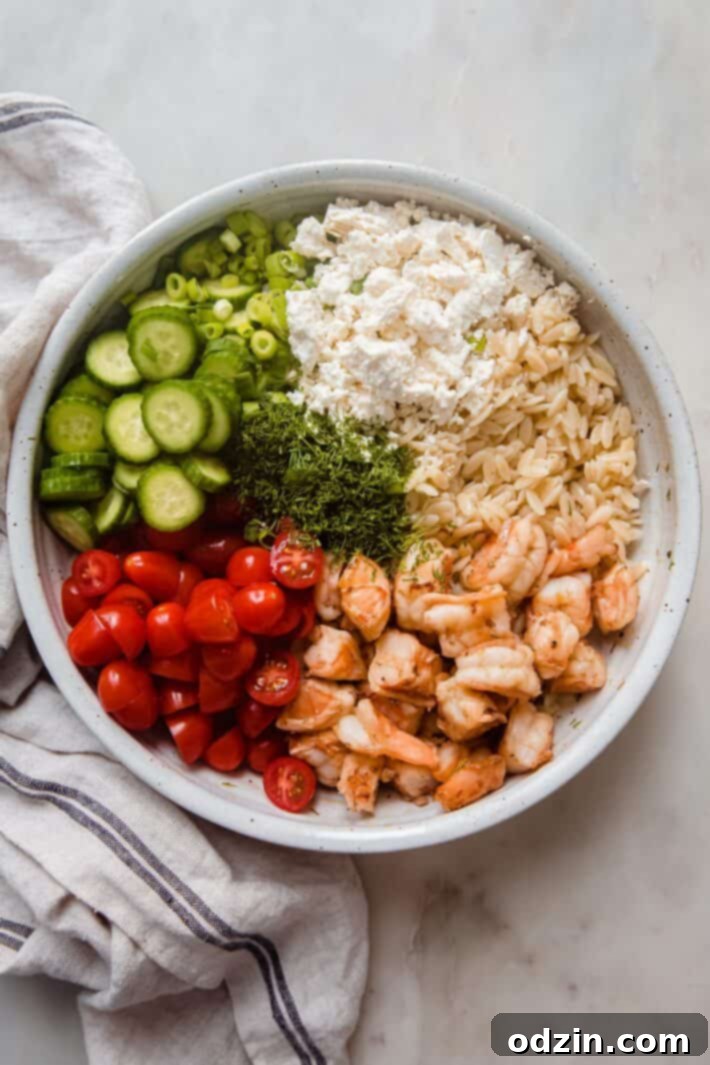 Riviera Prawn & Orzo Bowl 5 All the fresh ingredients for the Mediterranean shrimp orzo salad arranged in bowls