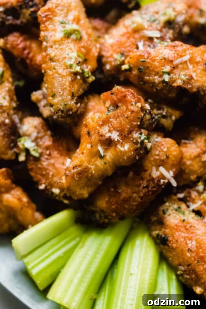 Shatteringly Crispy Garlic Parmesan Wings 9 golden drumstick with parsley, garlic, and parmesan on top