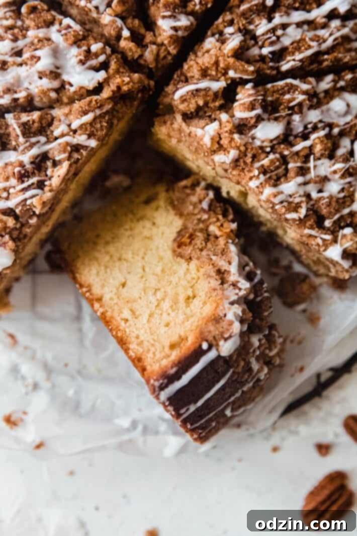 Decadent Brown Butter Cinnamon Pecan Coffee Cake 3 showing texture of coffee cake on white parchment