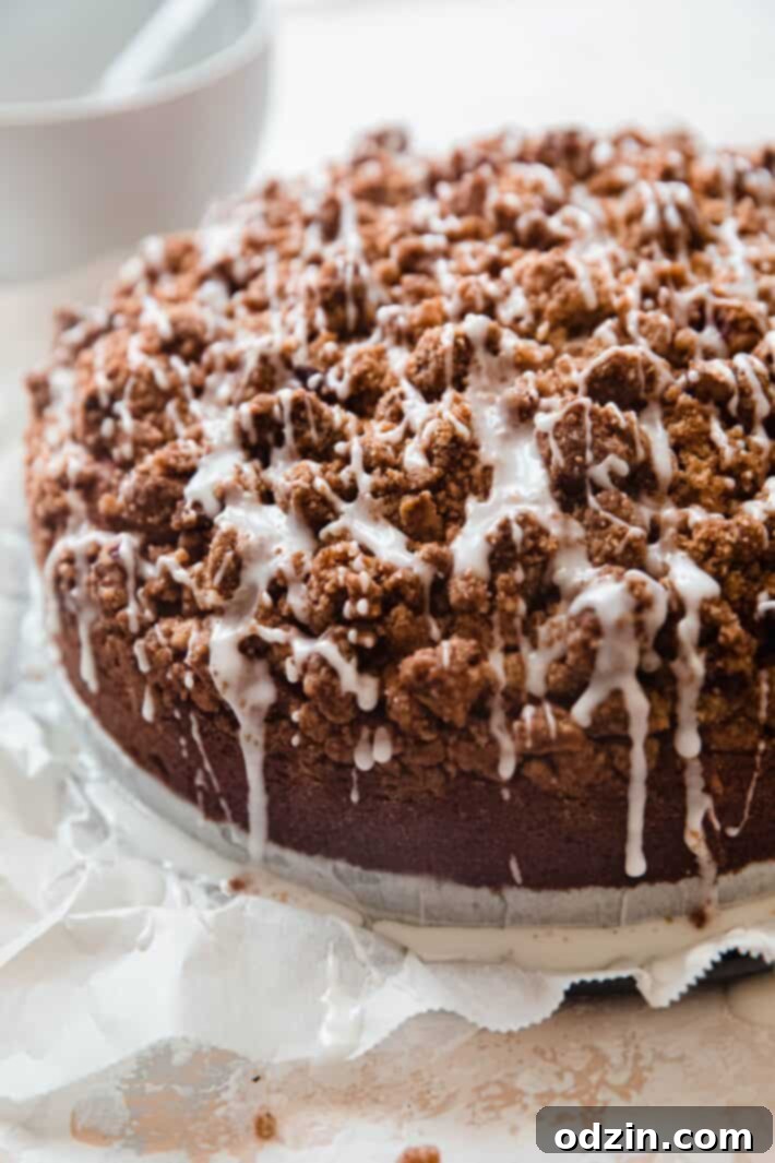 Decadent Brown Butter Cinnamon Pecan Coffee Cake 6 iced coffee cake on white parchment