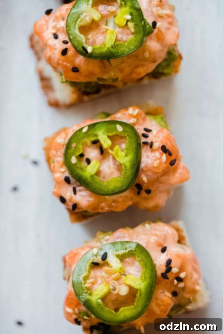 Spicy Salmon Crispy Rice Bites 3 spicy salmon on crispy rice cakes topped with jalapeno