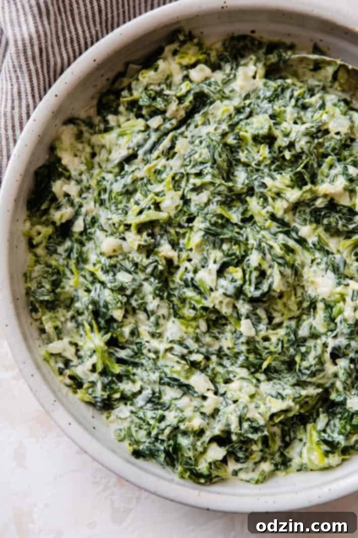 A generous serving of creamy homemade spinach in a rustic bowl, ready for a meal