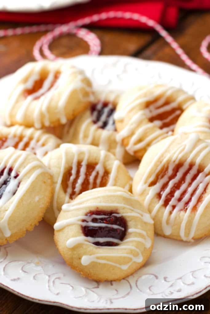 Vibrant apricot and raspberry thumbprint cookies, freshly baked and ready to enjoy.