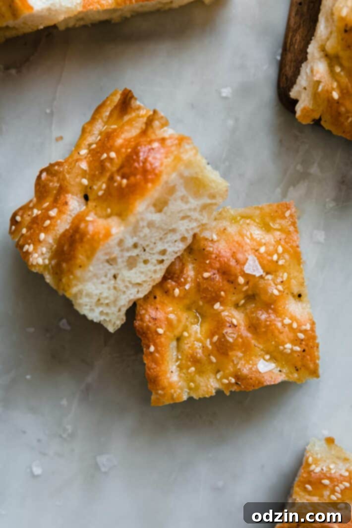 golden focaccia bread on white marble