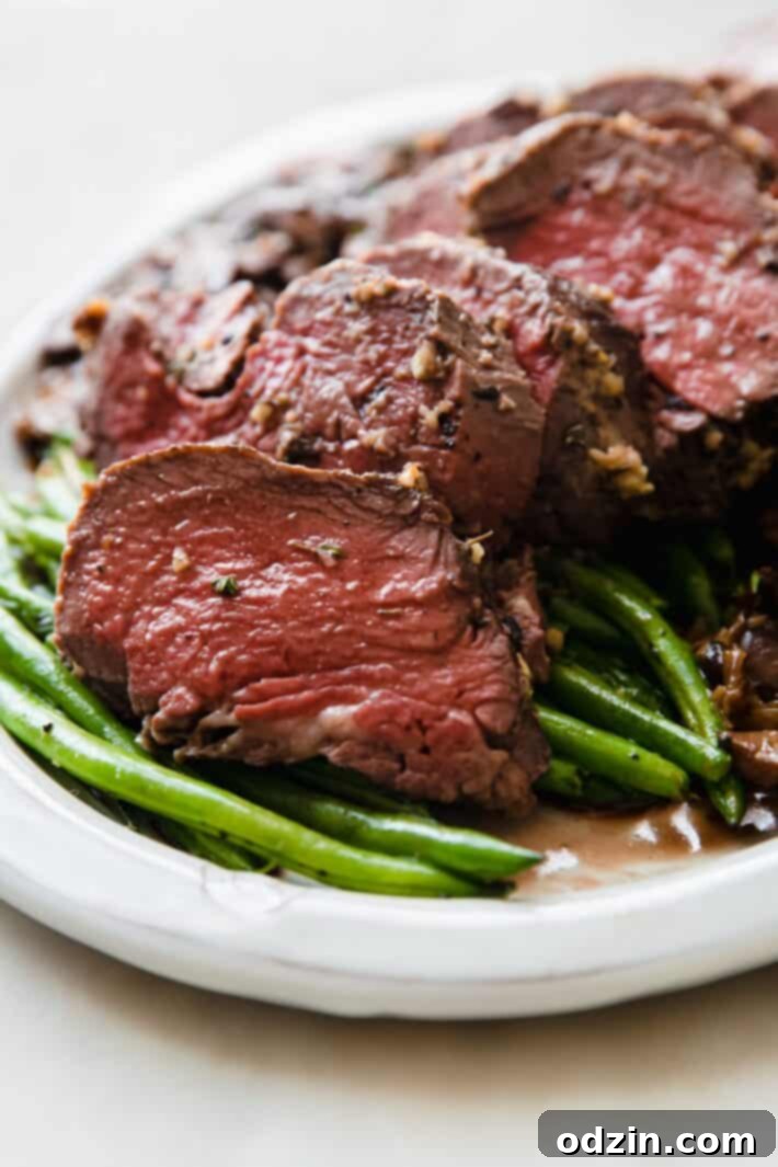 slice of roast beef tenderloin with green beans