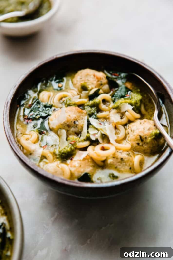 chicken meatball soup topped with parmesan and pesto