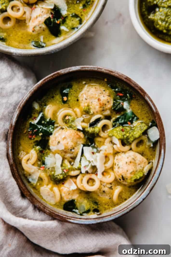 soup in bowl with parmesan and pesto on top