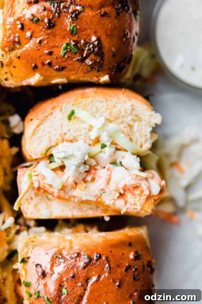 Buffalo Chicken Sliders: Spicy Bites, Creamy Slaw 3 close up of buffalo chicken slider with blue cheese and ranch slaw
