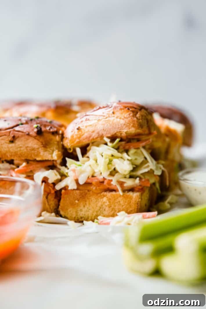 Buffalo Chicken Sliders: Spicy Bites, Creamy Slaw 5 slaw on sliders with celery sticks, ranch, buffalo sauce