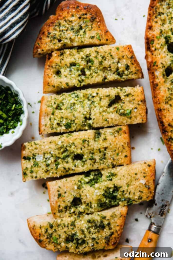 The Ultimate Garlic Bread 2 Sliced garlic bread on white marble countertop, ready to be served