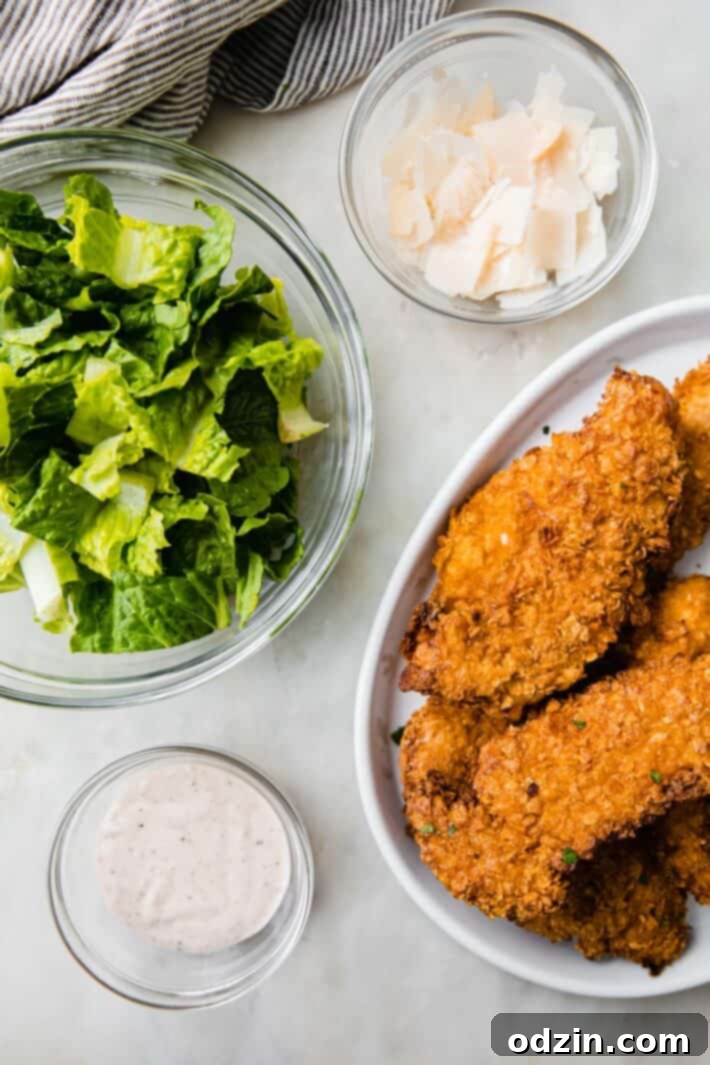 Caesar Crunch Chicken Wraps 4 Bowls of fresh ingredients ready for making chicken caesar wraps, including crispy chicken tenders, chopped lettuce, shredded parmesan, and creamy dressing.