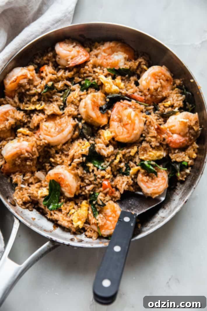 Holy Basil Fried Rice 3 frying pan with fried rice and spatula