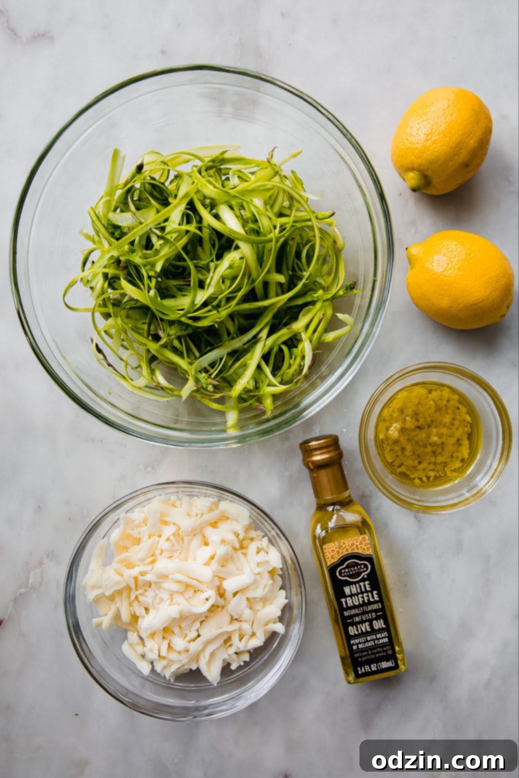 ingredients for flatbread with grated mozzarella and shaved asparagus, white truffle oil