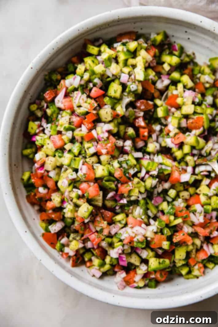close up of chopped vegetables in bowl with dressing