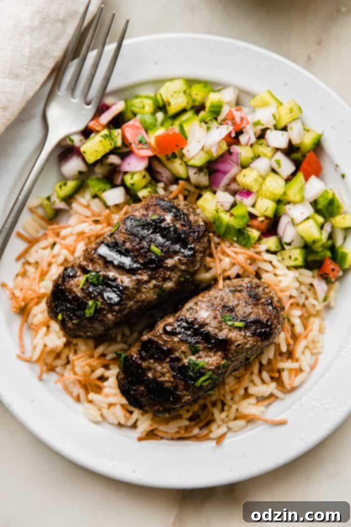 Beef Kafta on plate with rice and Shirazi salad