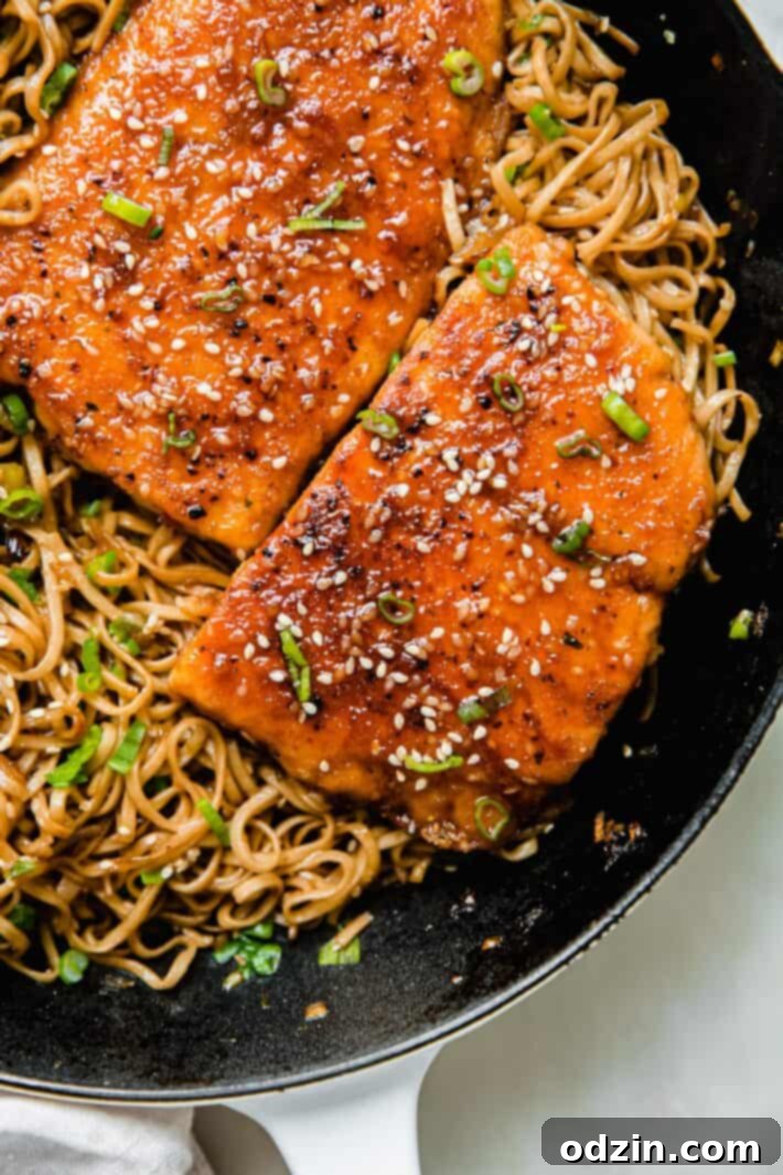 Sticky Teriyaki Salmon with Ginger Noodles 4 Prepared Teriyaki Sesame Salmon fillets, topped with vibrant scallions and toasted sesame seeds, served over a bed of ginger noodles.