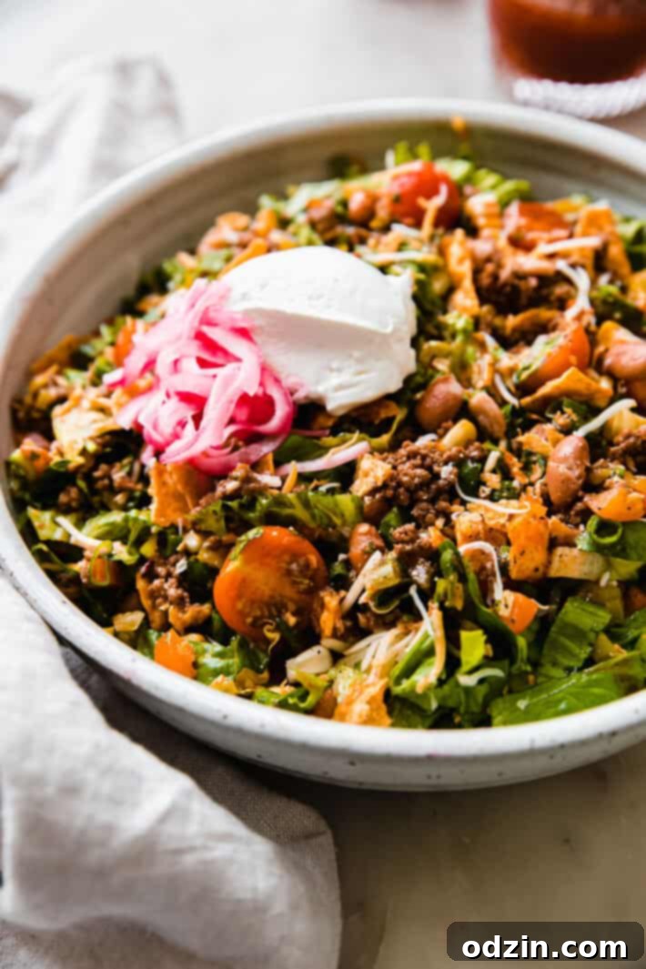 dressed taco salad in speckled bowl