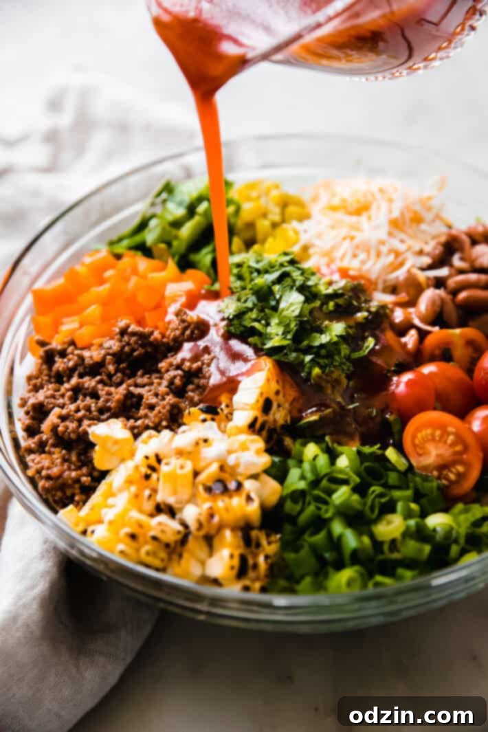 pouring dressing over salad