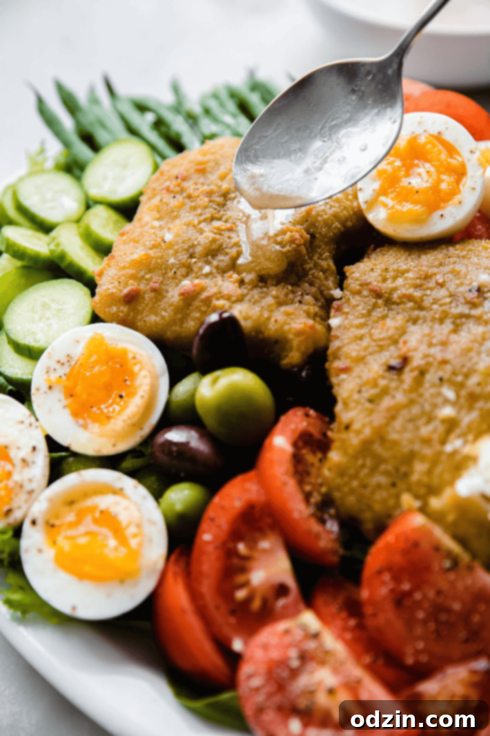 Pouring dressing on cod filet