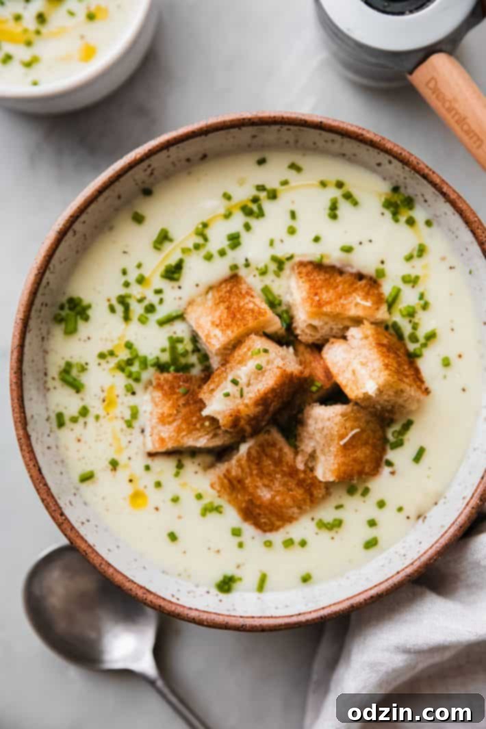 Velvety Roasted Garlic Potato Soup with Crispy Grilled Cheese Croutons 7 soup in bowl with grilled cheese croutons