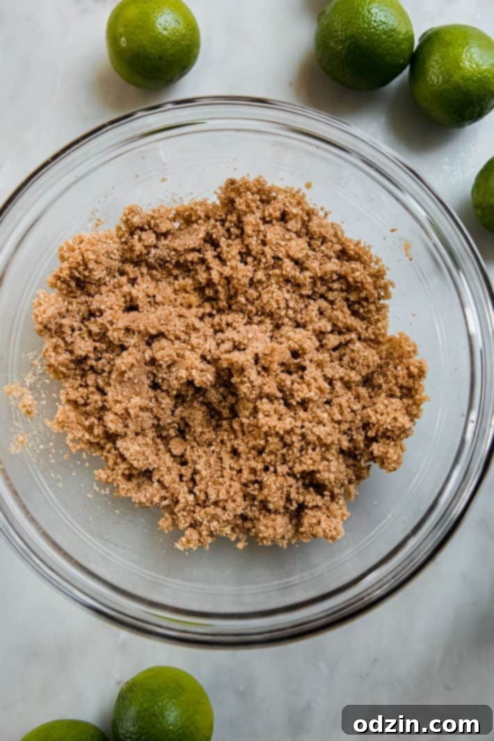 Bowl of graham cracker crumbs, ground pecans, sugar, and cinnamon for the pie crust