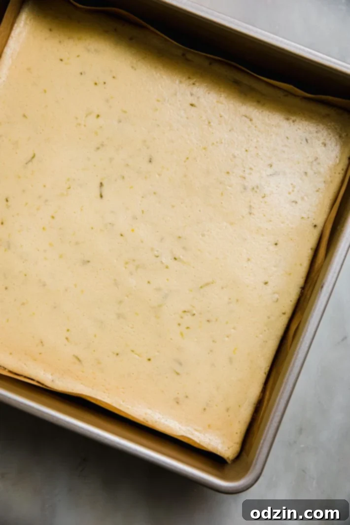 Baked key lime pie bars cooling in a baking pan