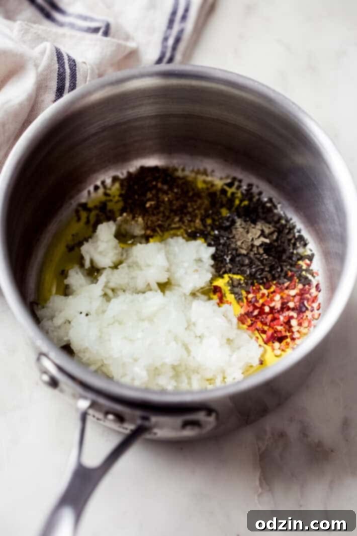 Sautéing Onions and Seasonings close up of onions and seasonings cooking in a saucepan