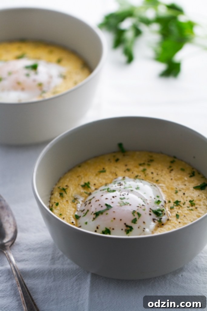 Close-up of a perfectly poached egg on Jalapeno Cheddar Grits, showcasing the creamy texture and vibrant colors. #poachedeggs #grits #comfortfood