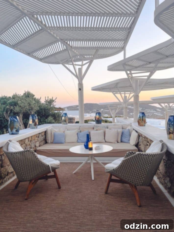 Outdoor sitting area at the Myconian Kyma hotel with comfortable furniture