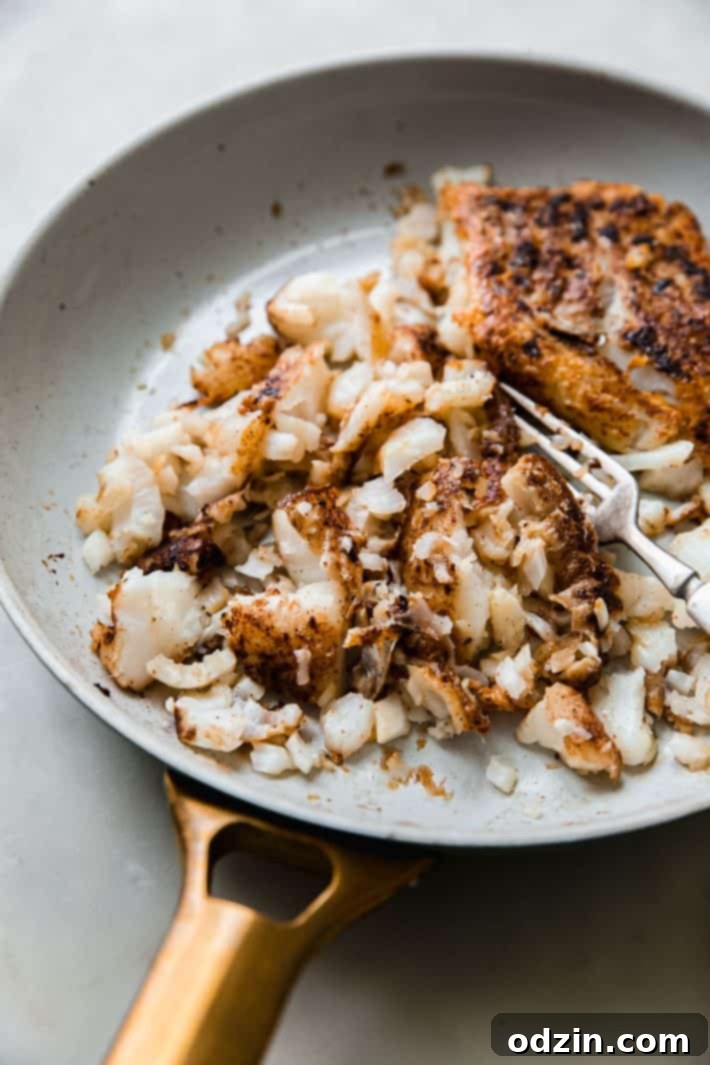 flaked fish in frying pan