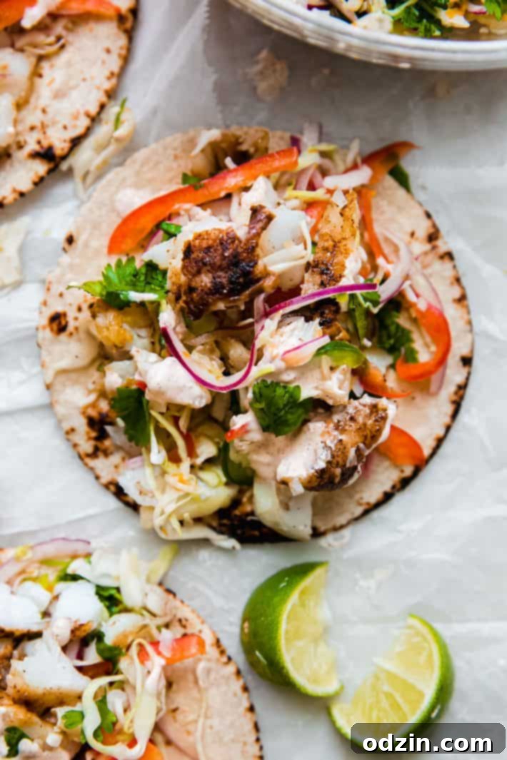 fish taco on parchment with slaw and chipotle sauce