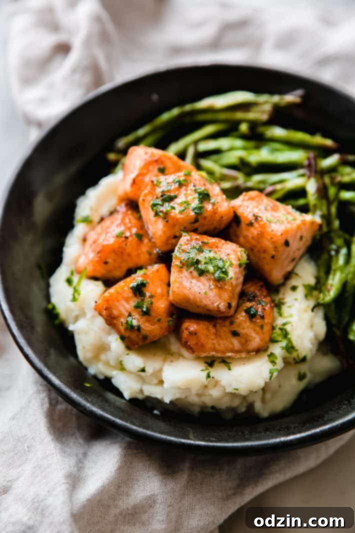 cajun salmon bites on mashed potatoes with green beans
