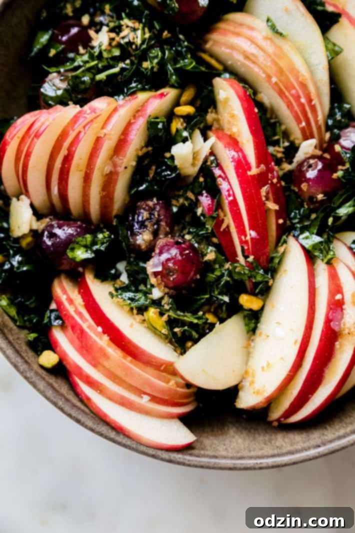 sliced apples with parmesan vinaigrette over kale