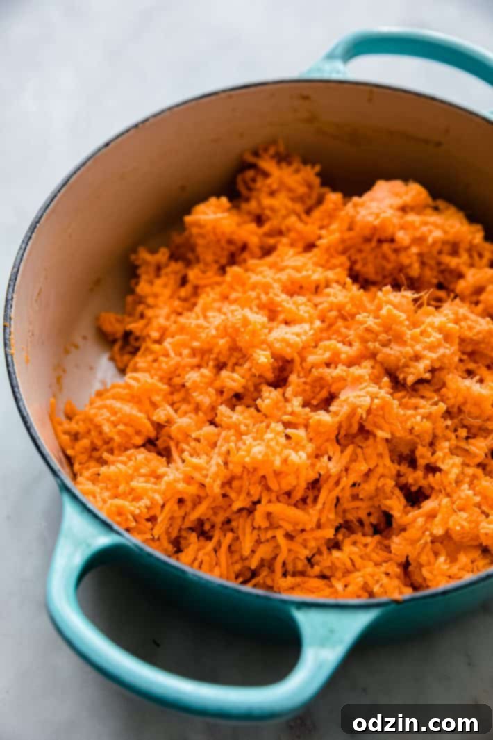 Freshly boiled and riced sweet potatoes ready for mashing in a cast iron dish