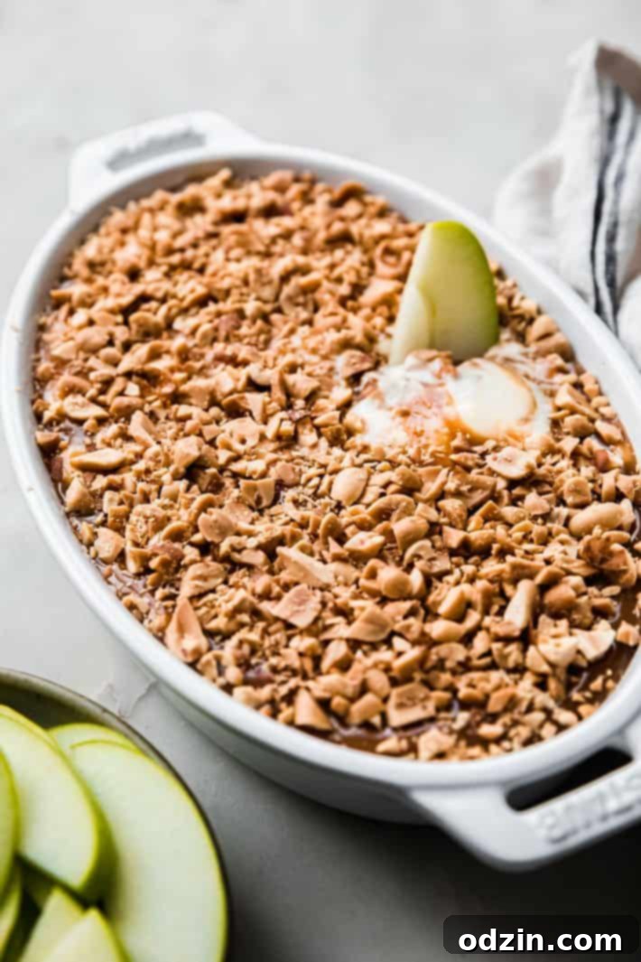 Granny Smith apple slice in caramel apple dip