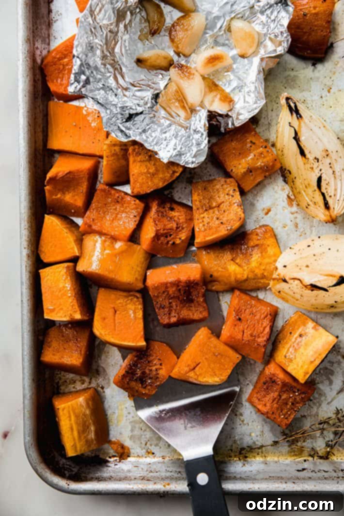 roasted honeynut squash, onions, and garlic on sheet pan