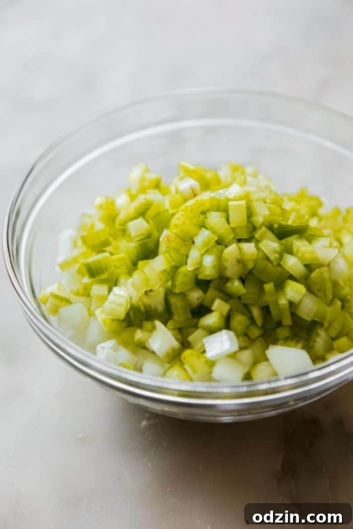 chopped onions and celery, prepared for sauteing in a bowl