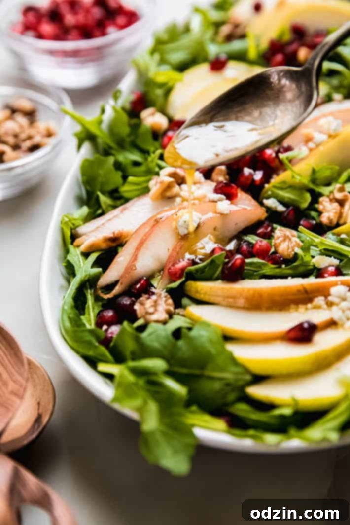 Drizzling homemade ginger honey vinaigrette over pear salad